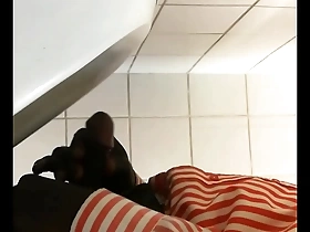 Public restroom urinal scene with a black gay man masturbating.