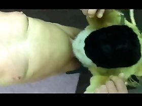 Gay man in fur coat suspended as BDSM slave.