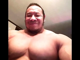 Young Asian bodybuilder shows off his muscles.