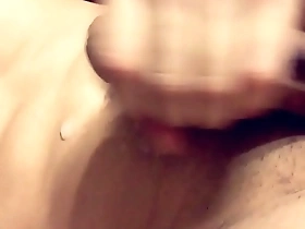 Asian man masturbates and has an orgasm with a stream of semen on his washboard stomach.