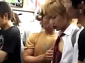 A young Japanese man gets a hand job on a train.