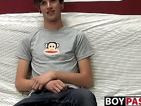 Danny, a cute gay guy, masturbates on the couch.