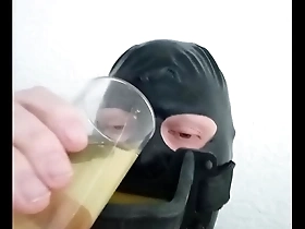 Gay BDSM gay piss drinking with a latex hood and urinal gag