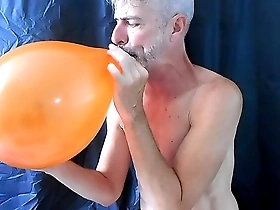 Gay DILF Richard Lennox has a balloon fetish and masturbates while playing with them.