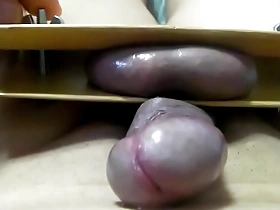 A BDSM-themed video of a masochistic man pleasuring his golden orbs.