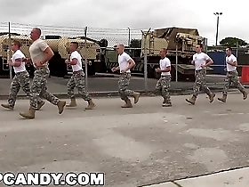 Muscular men in uniform have a group sex with an unknown partner in a gay orgy.